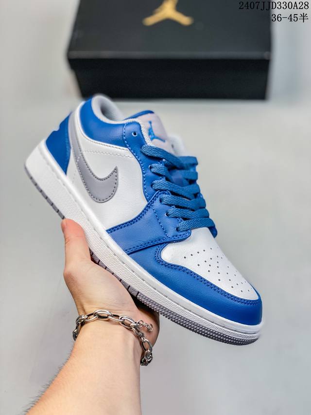 air Jordan 1 Low “True Blue” 整体的白色框架搭配上鞋头的灰色荔枝纹皮革，再加上鞋身中段黑色皮质材料的 Nike Swoosh，质感不